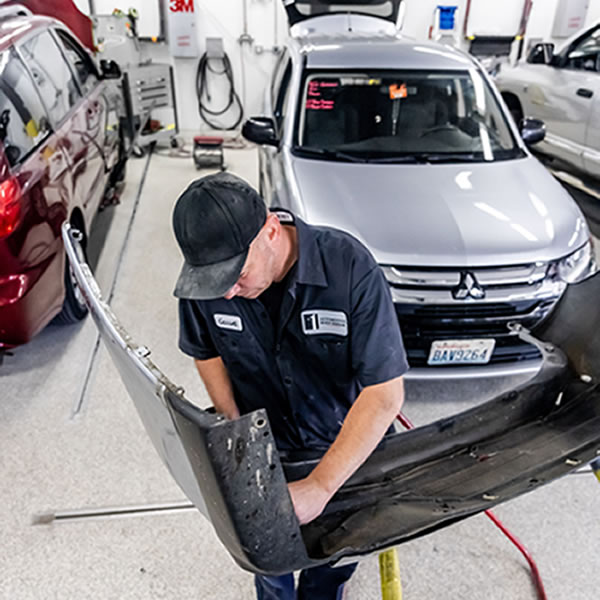 Man repairing car bumper