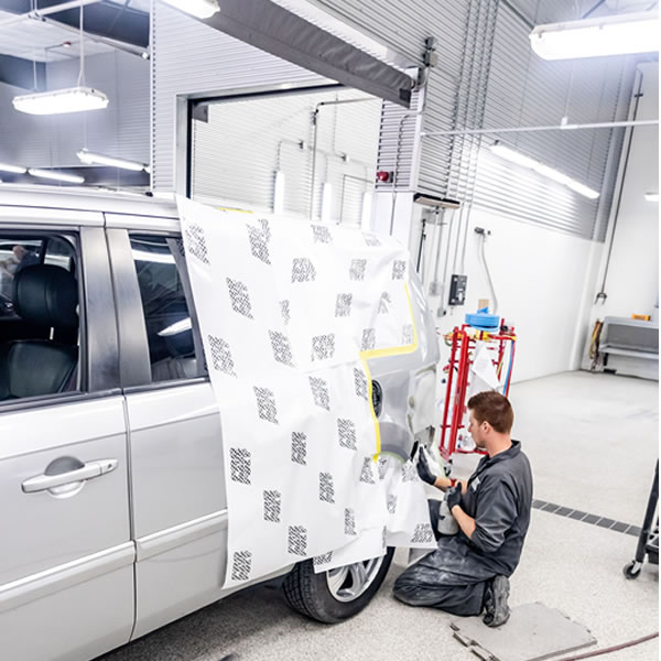 Man repairing car bumper